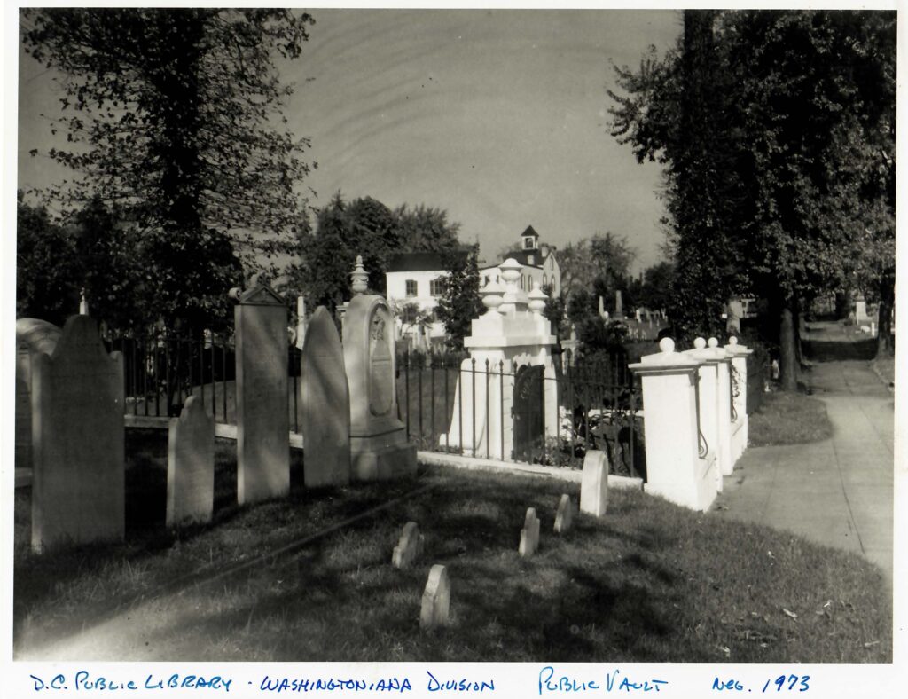 Black and quite image of a group of gravestones and the historic public vault